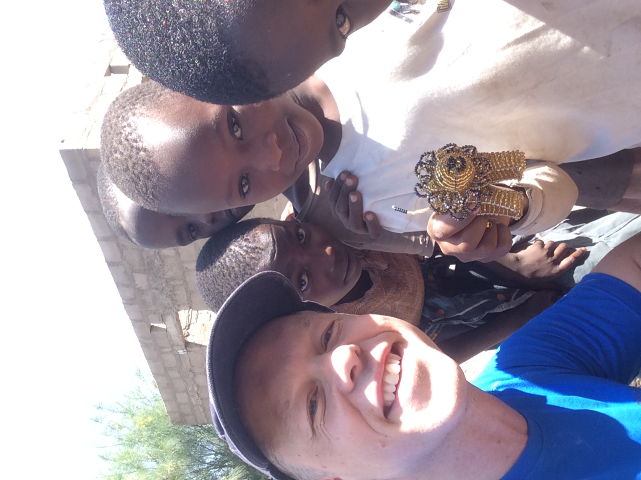 Dan Monaghan with young girls in beaded Maasai dress at Ketumbeine Village, Tanzania